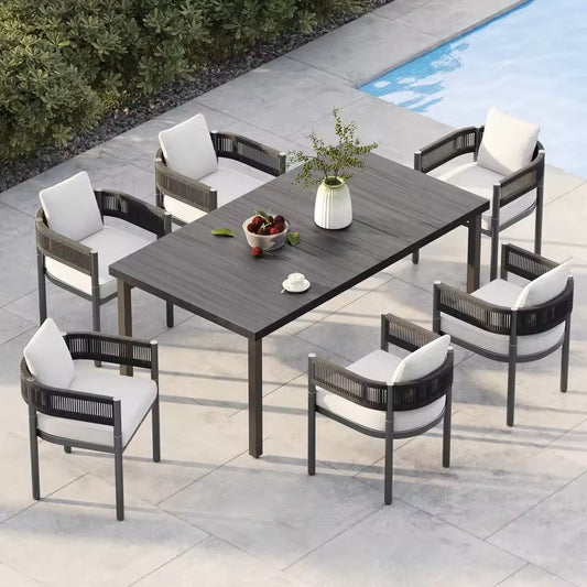 7-piece modern outdoor dining set with black metal table and hand-woven wicker chairs